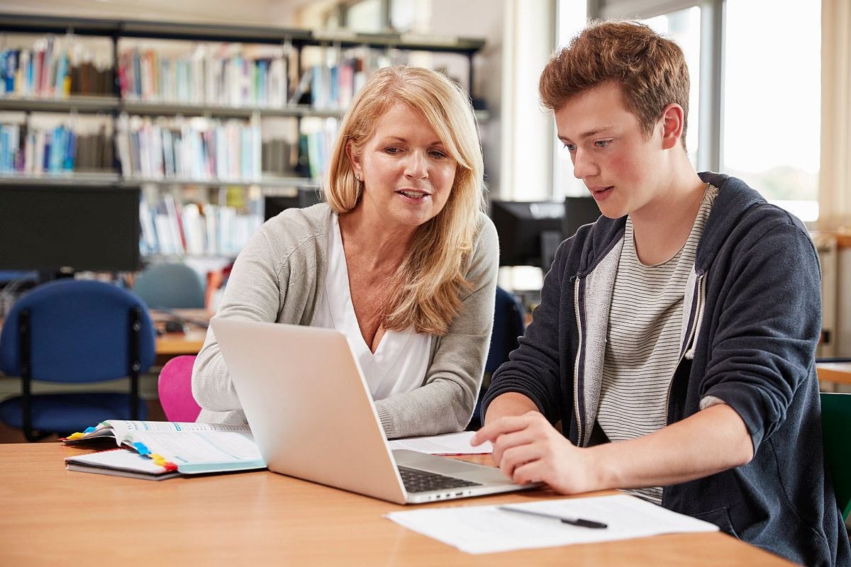 Student and Teacher In Library; online tools concept