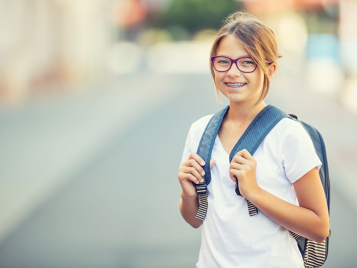 Schoolgirl with bag, backpack; side effects of remote learning concept