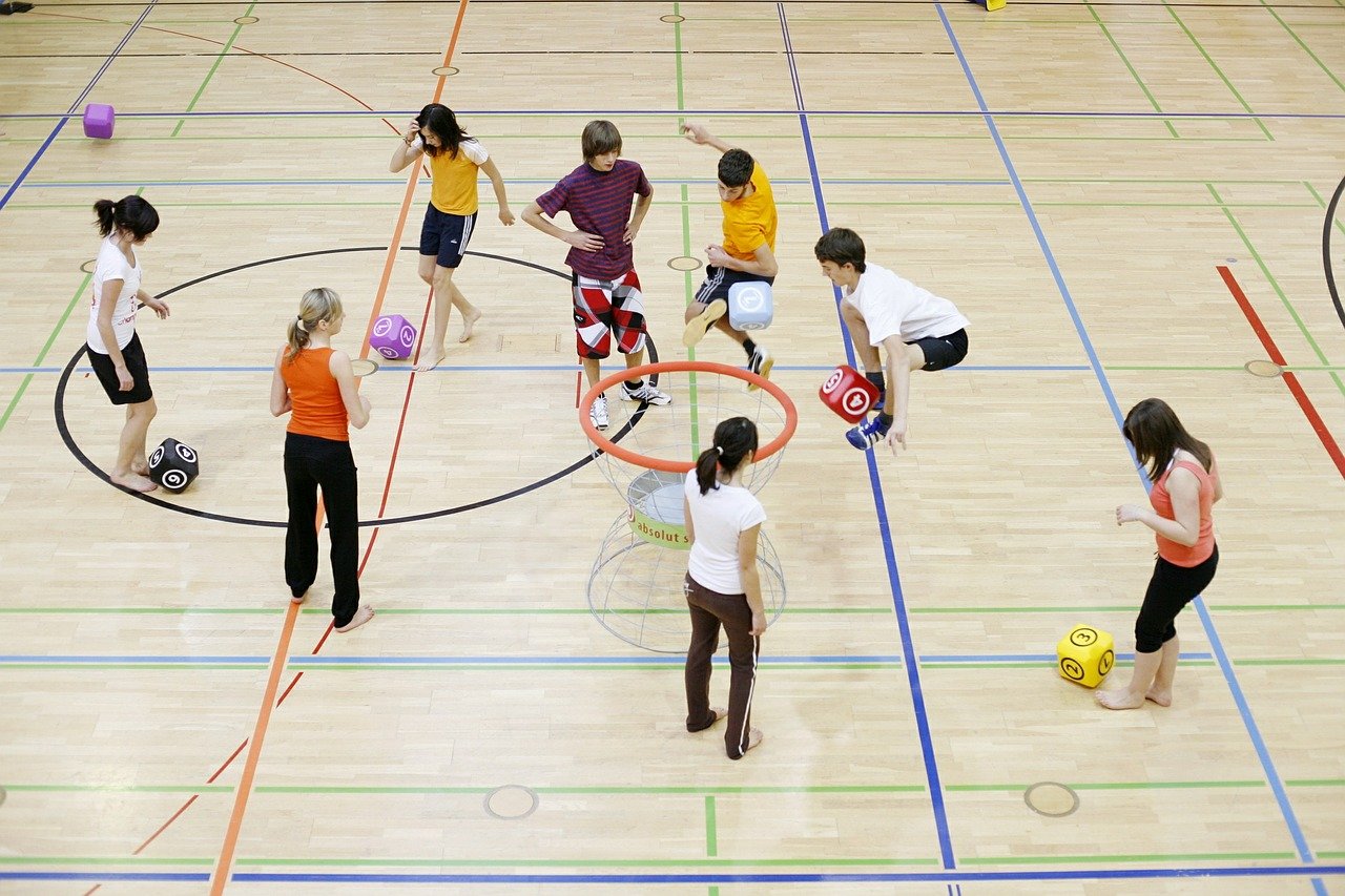 students playing in gym class; side effects of remote learning concept