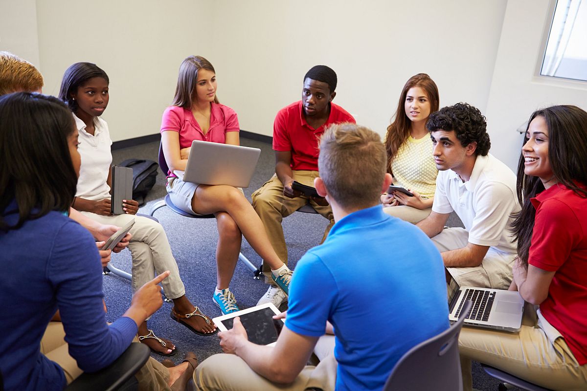 High School Students Taking Part In Group Discussion; teaching Columbus Day concept