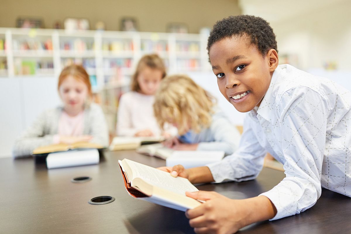 student and his study group do homework at school; halloween classic literature concept