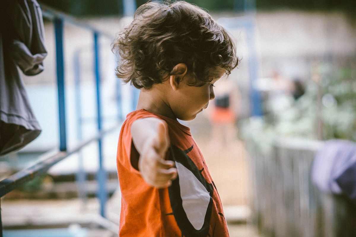 young student in sport clothes stretching; indoor recess concept