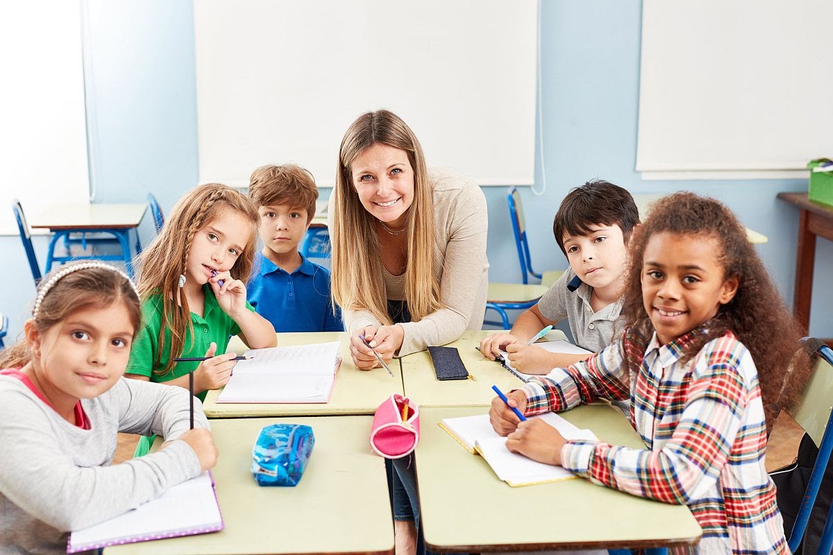 Group of elementary students in tutoring lessons with teacher; substitute teachers concept