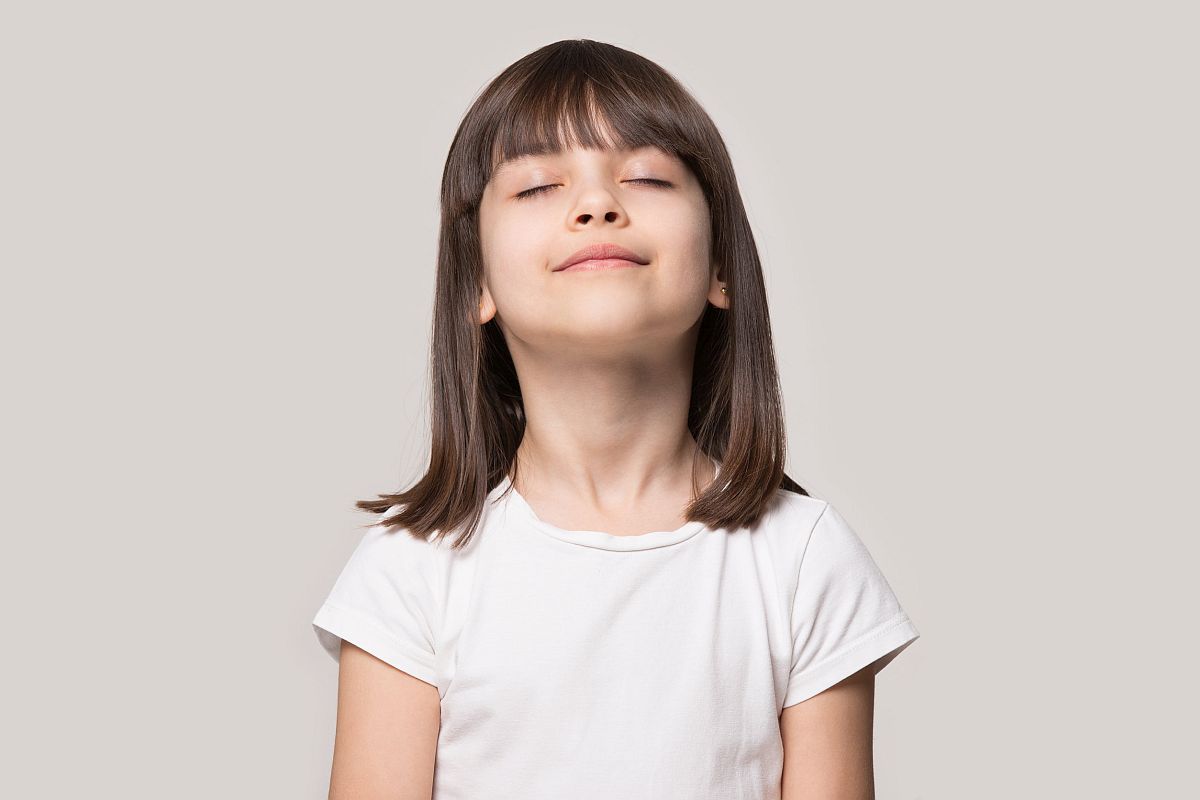 Brown-haired girl with eyes closed; self-calming strategies for students concept
