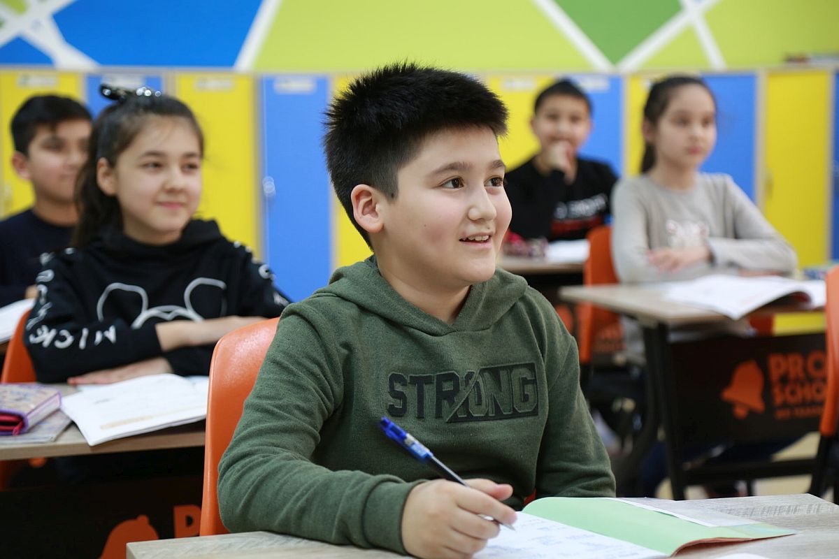 smiling children in a classroom; mental health of teachers concept