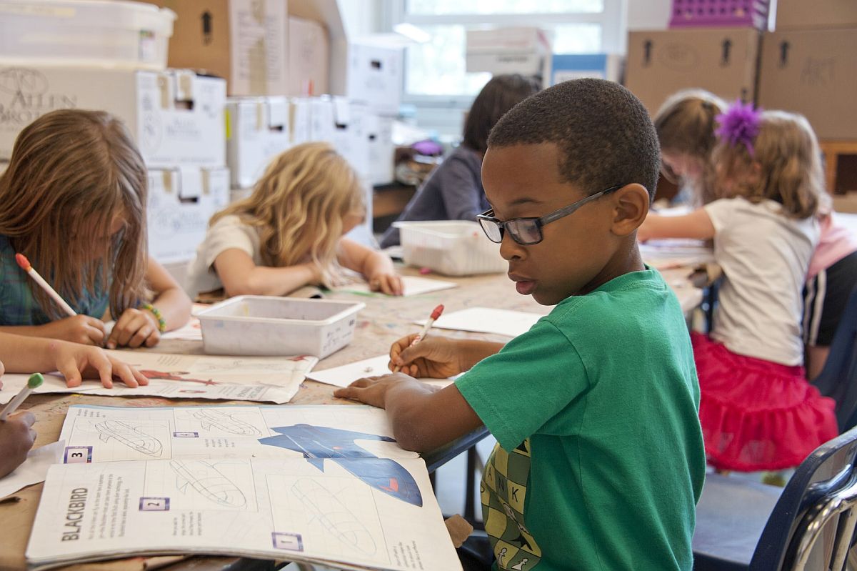 Classroom of young students working on assignment; academic self-esteem concept