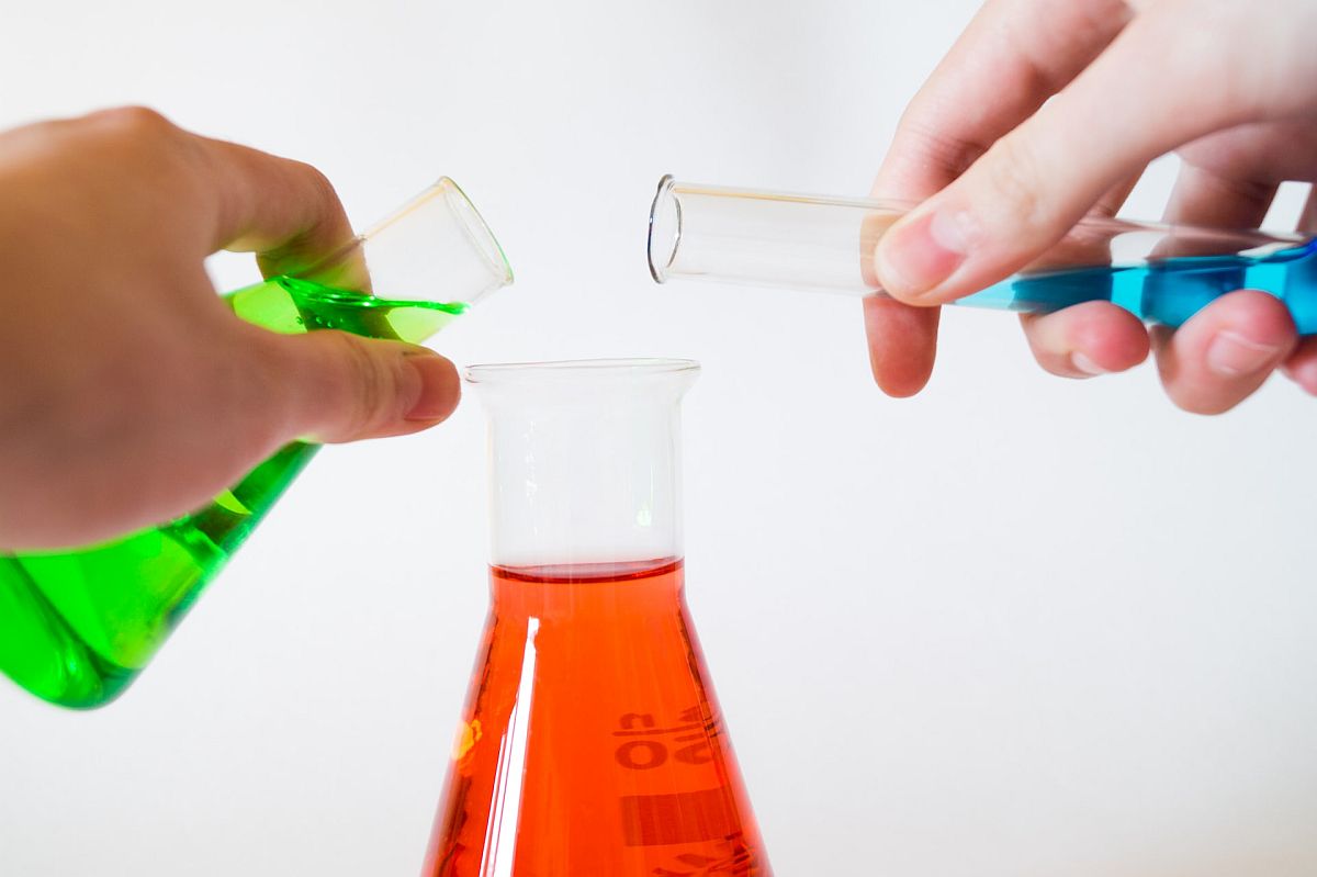 Close-up of beakers and test tubes with different color liquids; chemistry classroom concept