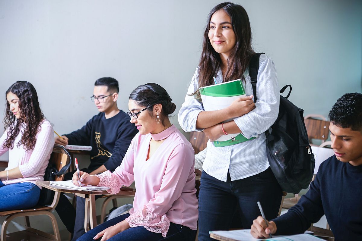 Students taking notes in classroom; edtech tools concept