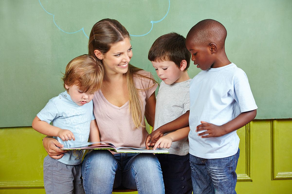 Teacher reading with young students; boost reading skills concept