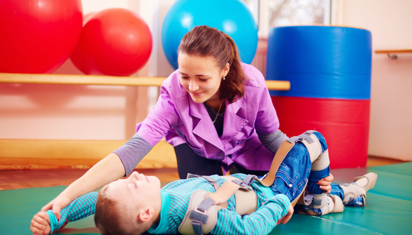 Physical therapist helping student with exercise; physical therapists role concept