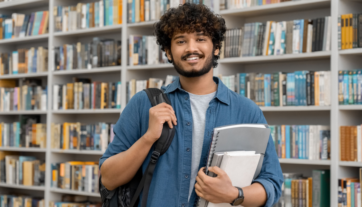 Smiling college student in library; career counselors concept