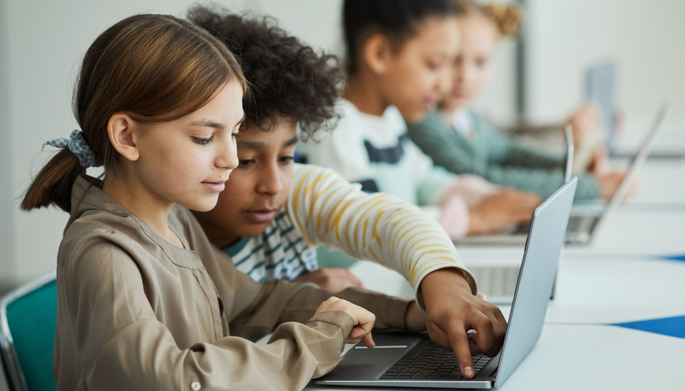 Students working together on laptops in classroom; AI-generated content concept